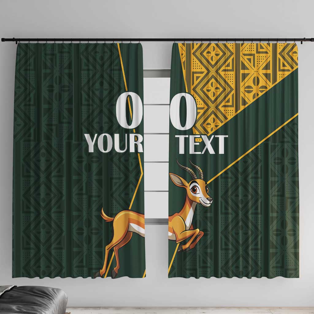 Green window curtains with springbok graphic and yellow geometric Kente-style pattern