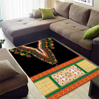 Black area rug with embroidered floral panel and bright geometric trim