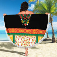 Round black beach blanket with V-neck floral embroidery, striped border, and white tassel fringe