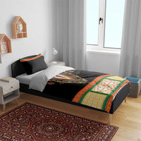 Black dashiki bedding set on bed with multicolor V embroidery and geometric border stripe