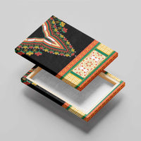 Black canvas wall art angled on a wooden base, embroidered floral V-neckline design