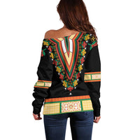 Back view black off-shoulder sweater with colorful embroidered V panel and floral trim