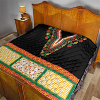 Black quilt bedspread with embroidered V-neck floral center and patterned green, orange, yellow border