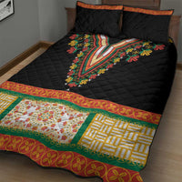 Black quilt bed set with colorful embroidered V-panel and floral trim, plus two pillows