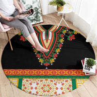 Black round rug with central V-shaped floral embroidery and multicolor patterned edge