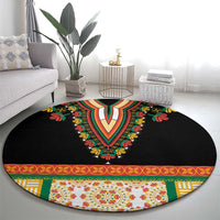 Black round embroidered carpet with bold V motif, floral details, and decorative border