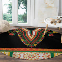 Black round rug with central floral V design and striped patterned border trim