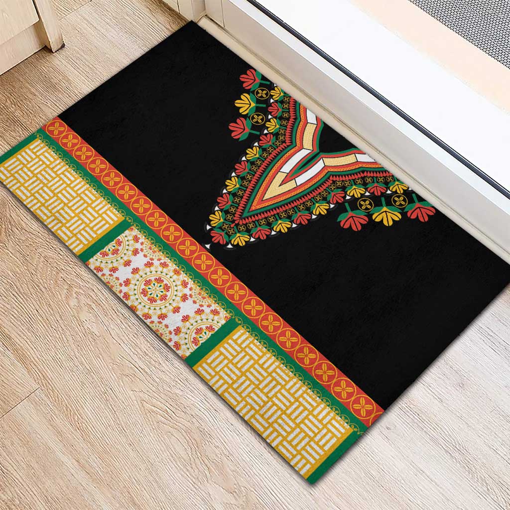 Black doormat with striped green and yellow border and V-shaped floral embroidery