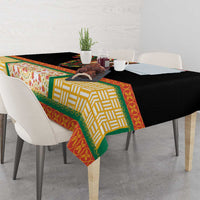 Black tablecloth with colorful border and floral center panel on dining table