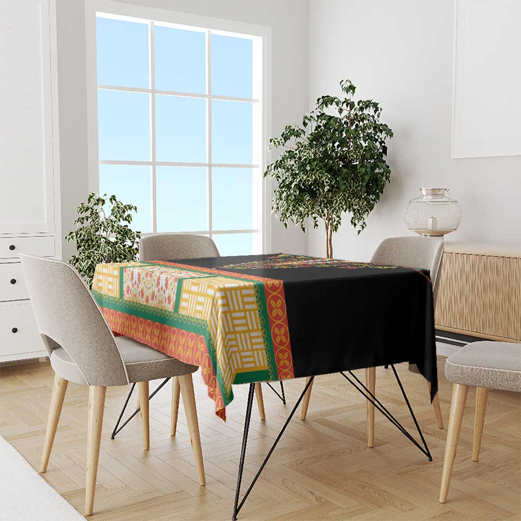 Black tablecloth with colorful geometric and floral trim on dining table with chairs