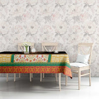 Black tablecloth with colorful geometric border and floral accent panel on table