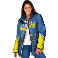 Blue padded jacket with yellow sleeves, front Knights emblem and high collar, zip front