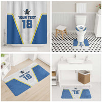 White shower curtain and blue-white bath mats with yellow trim, custom text 18