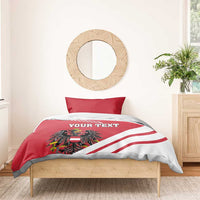 Red and white duvet bedding set with 'YOUR TEXT' crest and diagonal striped flag design