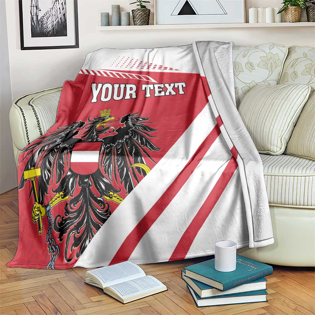 Personalized blanket over sofa: red/white diagonal stripes, black crest, and 'YOUR TEXT'
