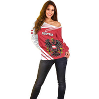 Women’s off-shoulder sweater with AUSTRIA text, red-and-white flag print crest