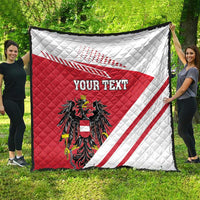 Red and white quilt flag blanket with Austrian crest, diagonal stripes, and 'YOUR TEXT' spread outdoors