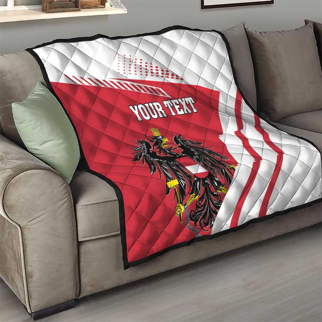 Red and white quilt flag blanket with Austrian crest and 'YOUR TEXT' on gray sofa