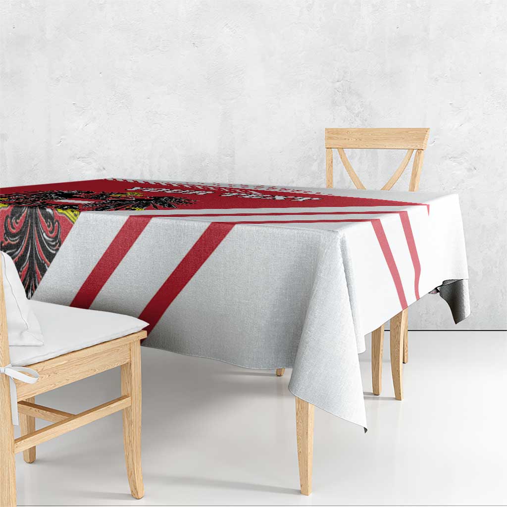 Red and white striped tablecloth covering a dining table with draped corners