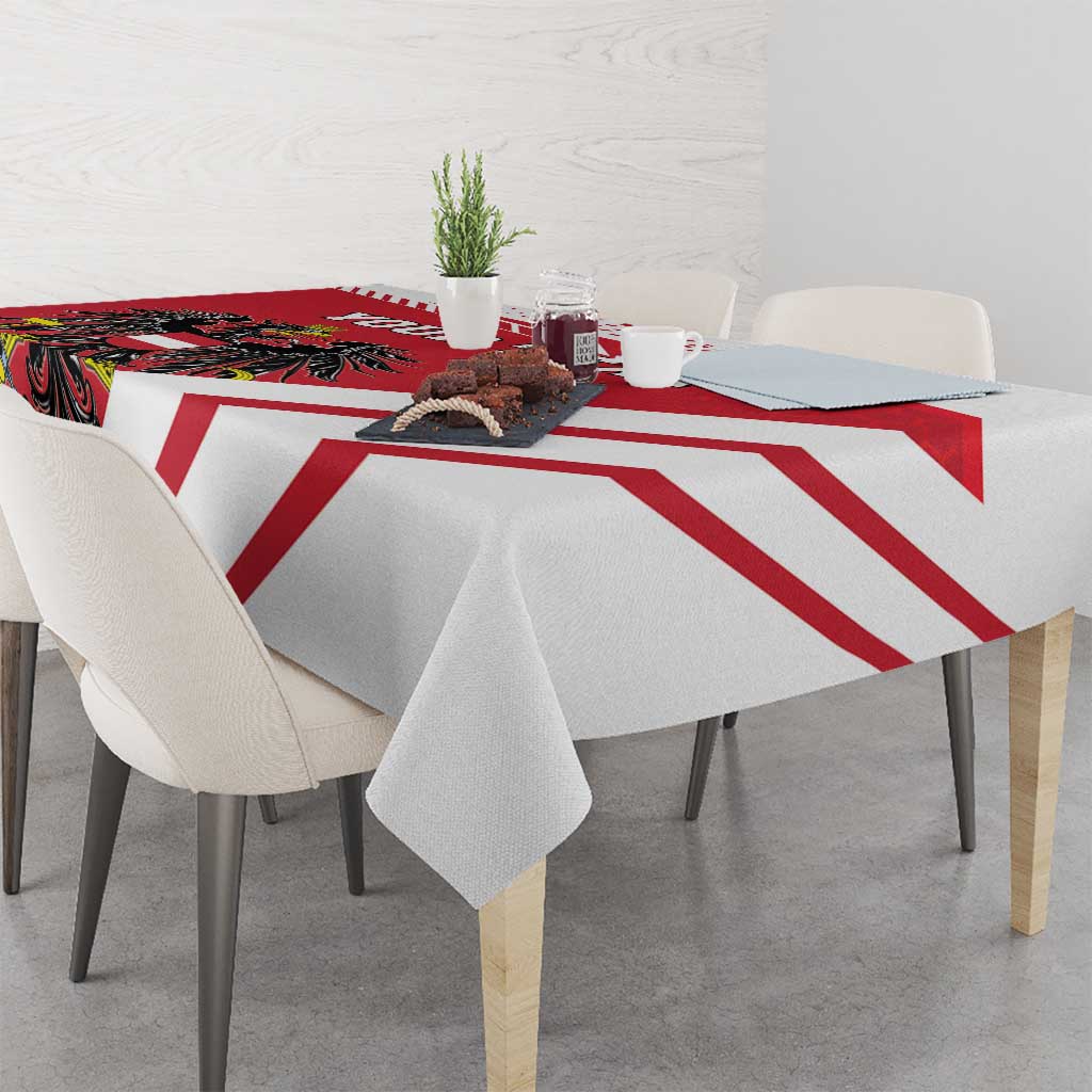 Red and white striped tablecloth on a dining table with a central coat-of-arms panel