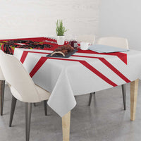 Red and white striped tablecloth on a dining table with a central coat-of-arms panel