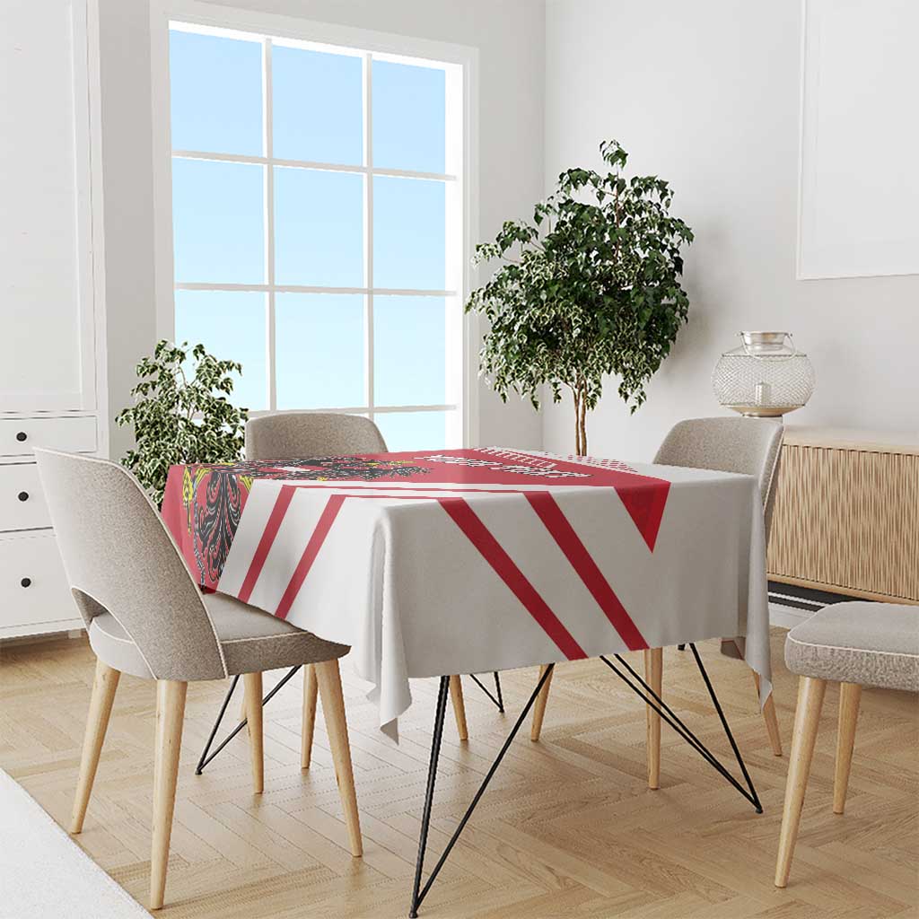 Red and white striped tablecloth on a dining table with four chairs