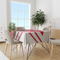 Red and white striped tablecloth on a dining table with four chairs