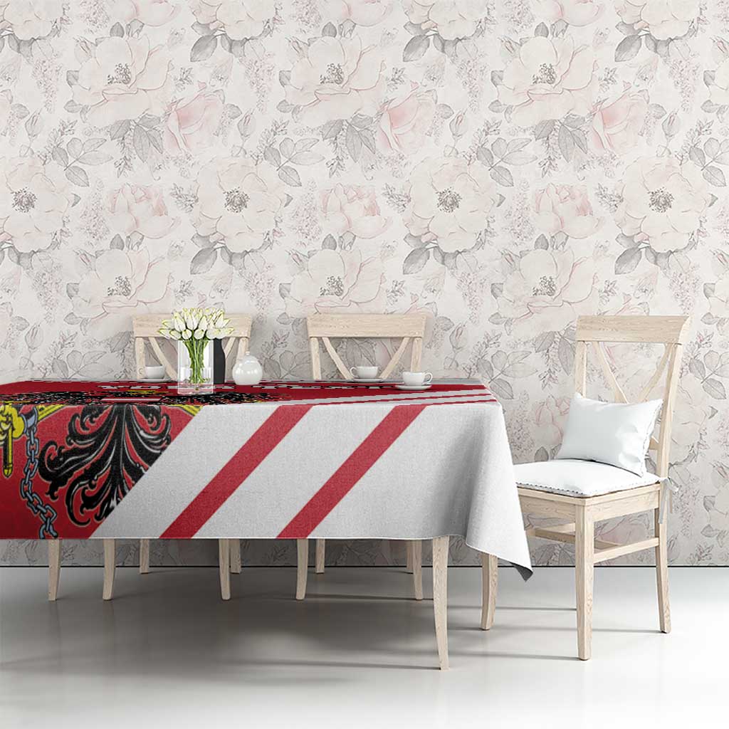 Red and white striped tablecloth with coat-of-arms motif on a dining table