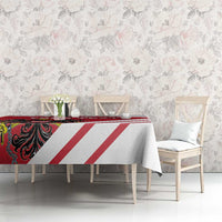 Red and white striped tablecloth with coat-of-arms motif on a dining table