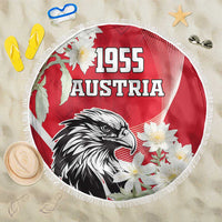 Round red beach blanket with 1955 Austria text, eagle graphic, white flower print, fringe