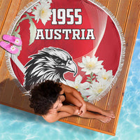 Round red beach blanket with 1955 Austria text, eagle and white flowers, circular fringe edge