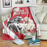 Red and white Austria blanket featuring eagle head, “1955” and blooming white flowers