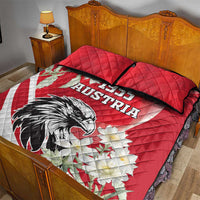Red quilt bed set with 1955 Austria eagle print and white stripe banner; red quilt top and pillows