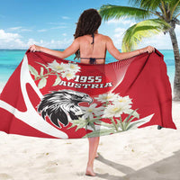 Red sarong with 1955 Austria lettering, eagle head, and white flower cluster