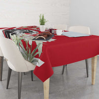 Red tablecloth with eagle and white flower details, draped on dining table