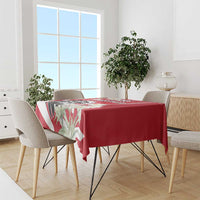 Red tablecloth with eagle and blossom print, on dining table with four chairs
