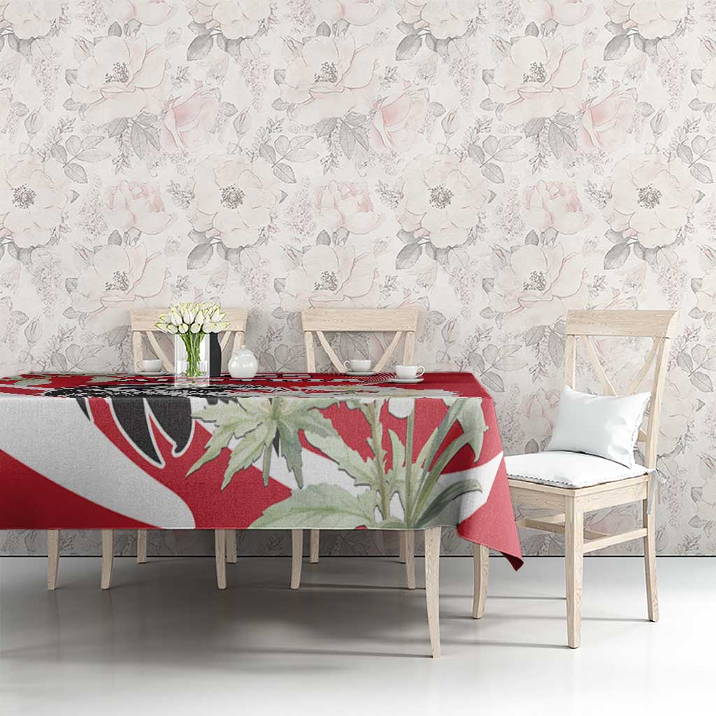 Red tablecloth with large flower and eagle graphic, set on dining table