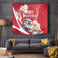 Red wall tapestry with Austria 1955 lettering, eagle emblem, and white edelweiss flowers
