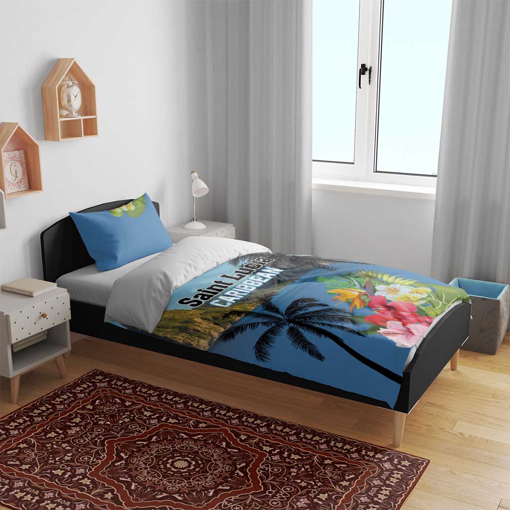 Blue bedding set on bed: duvet cover and pillow shams with tropical palms and flowers