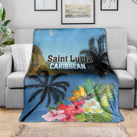 Blue tropical blanket on gray sofa with palm trees and hibiscus flowers print