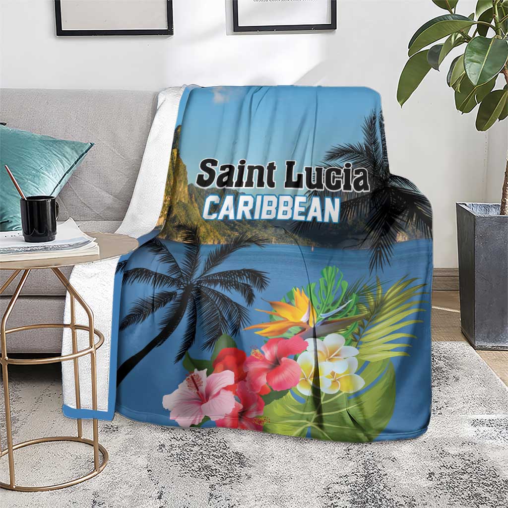 Blue tropical blanket on floor with palm trees and hibiscus flowers, 'Saint Lucia' text