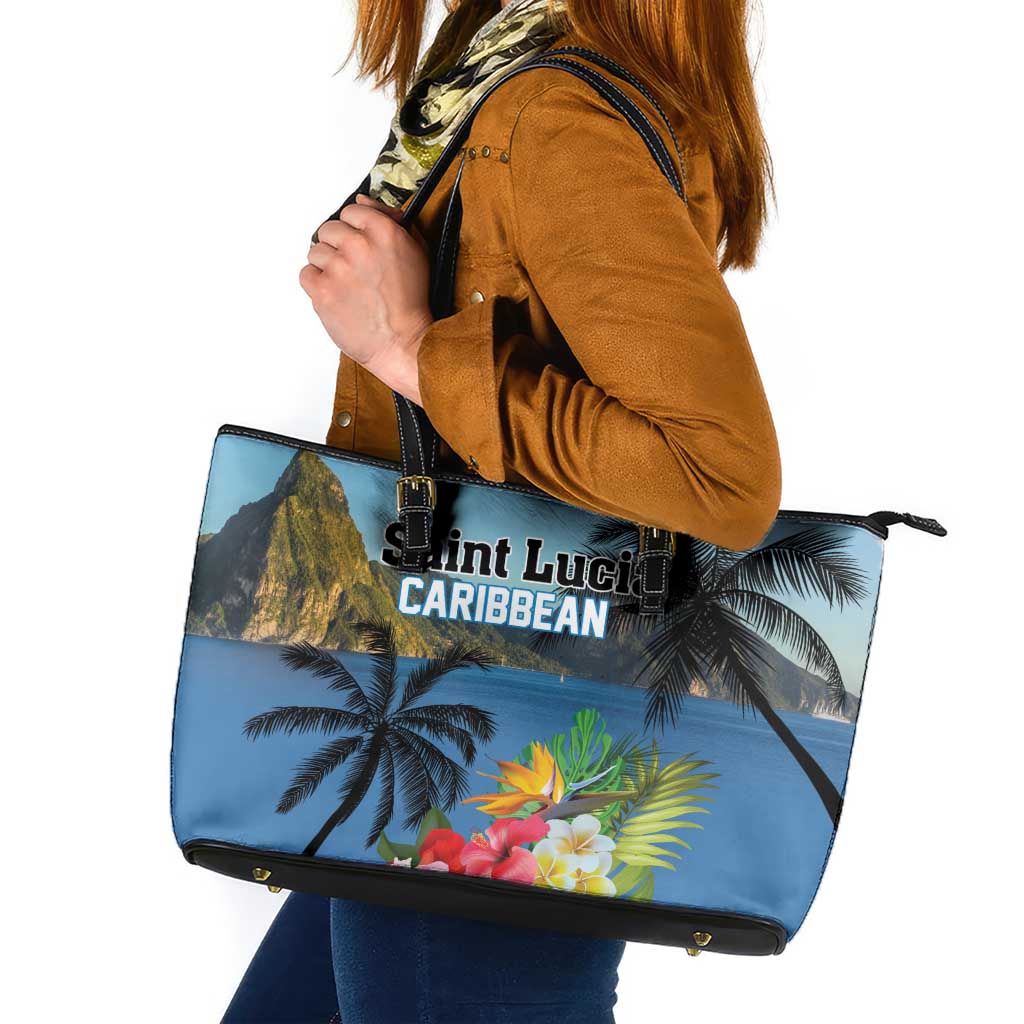 Blue tote bag with tropical print, black handles, zip top and gold hardware