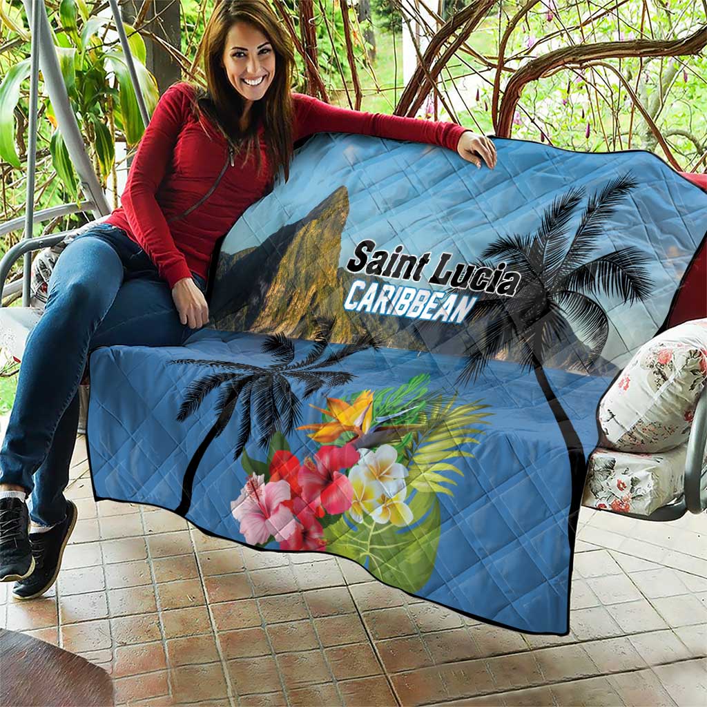 Blue quilt draped outdoors with mountain peak, palms, hibiscus flowers, and 'Saint Lucia Caribbean'