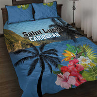 Blue quilt bed set with palm trees, Saint Lucia text, and hibiscus flowers; matching pillows