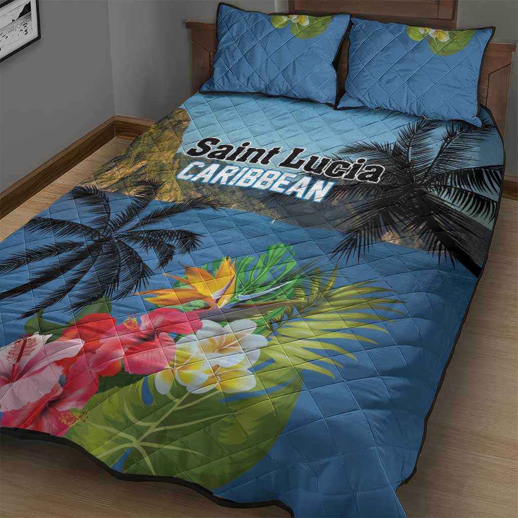 Blue quilt bed set with palm leaves and large hibiscus-style flowers; two matching pillows
