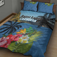 Blue quilt bed set with palm leaves and large hibiscus-style flowers; two matching pillows