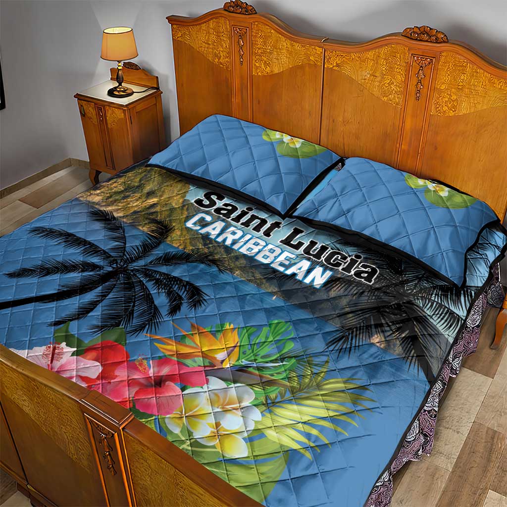 Blue quilt bed set with palm trees and hibiscus flowers; two square pillows on bed