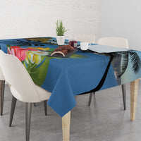Blue tablecloth with hibiscus flowers and palm leaves, draped across dining table