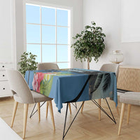 Blue floral tablecloth with hibiscus and palm leaves on dining table