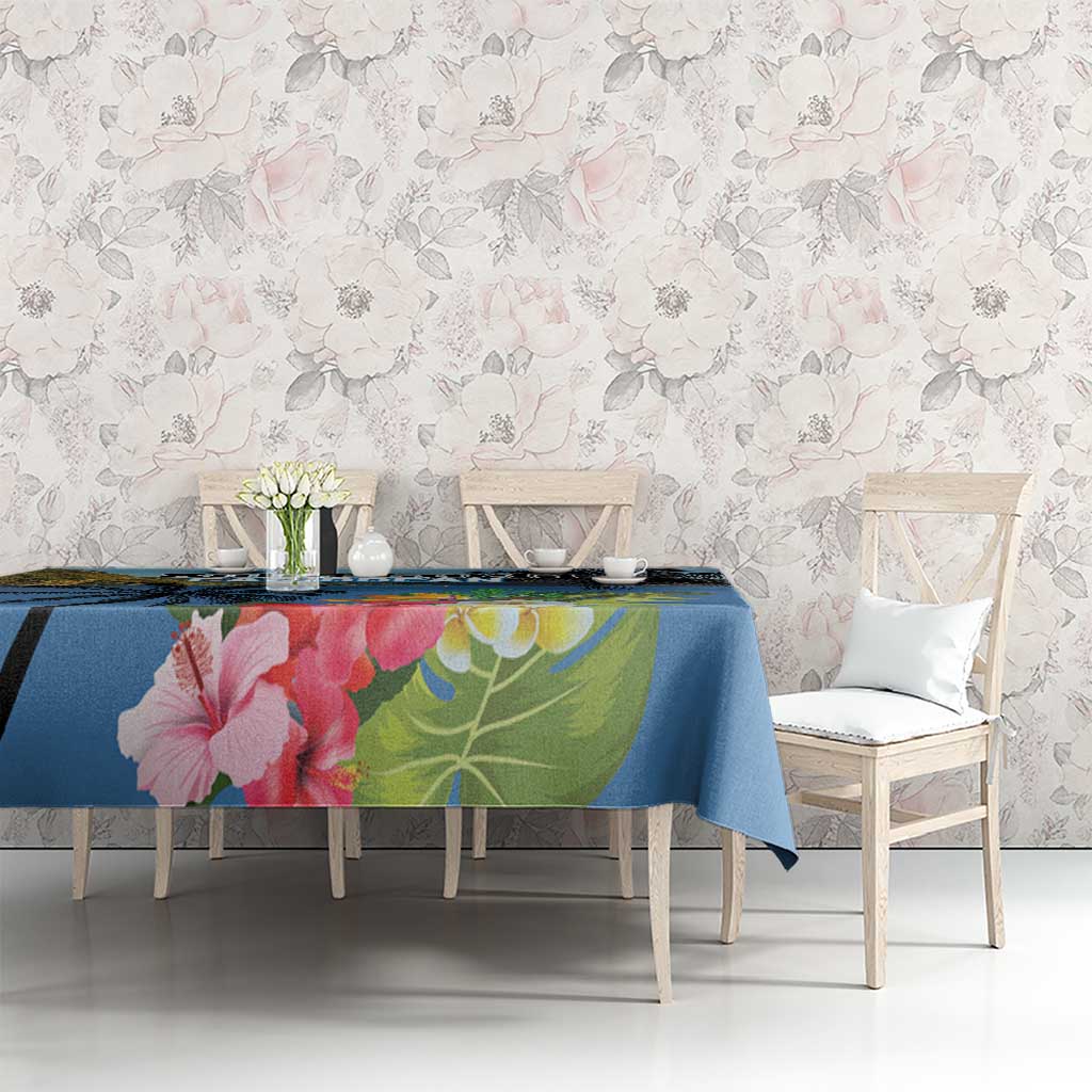 Blue hibiscus and palm leaf tablecloth laid on dining table